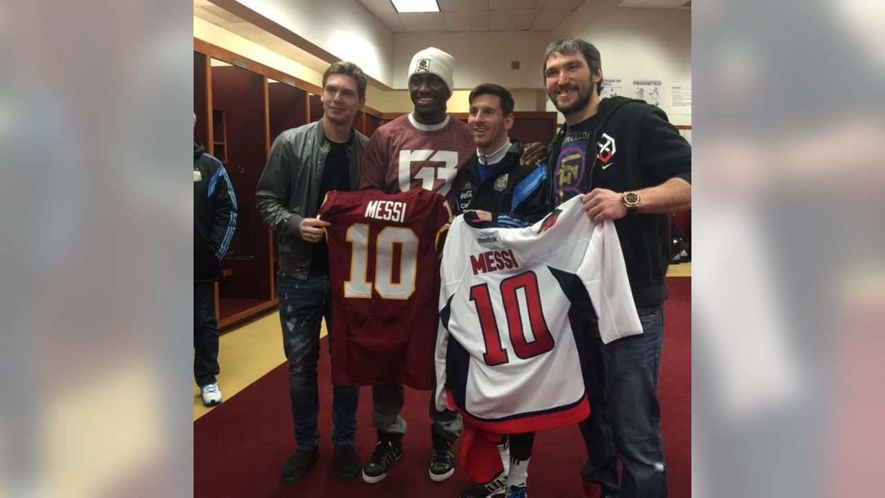 LOOK: Robert Griffin III presents Lionel Messi with Redskins