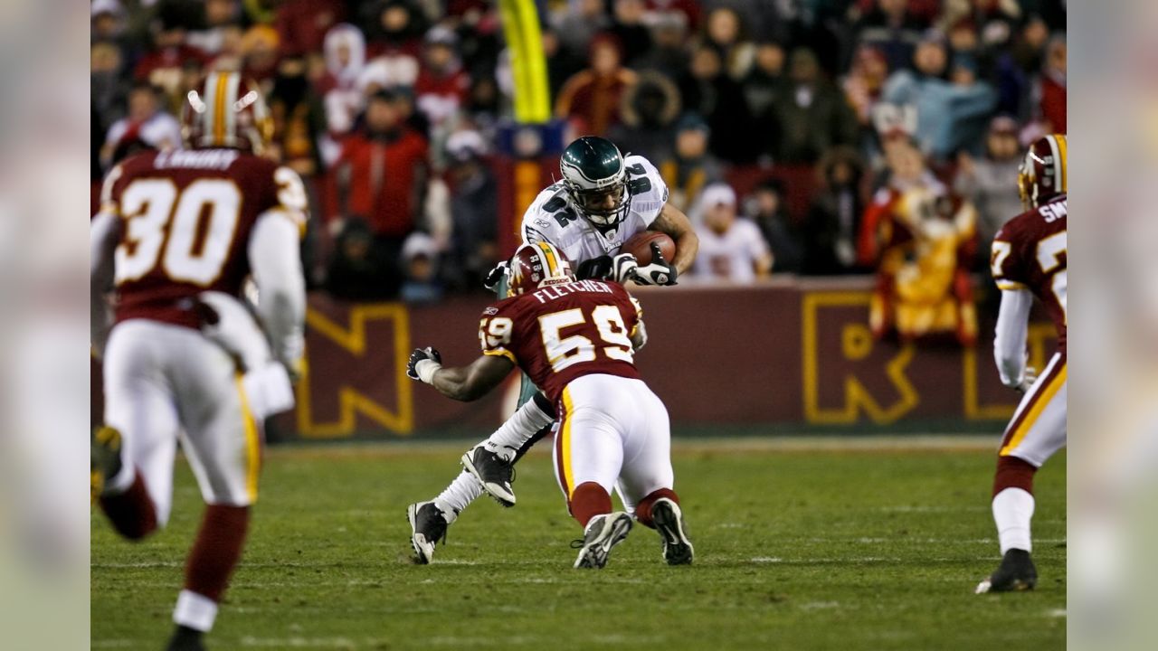 A member of the Washington Redskins maintenance staff takes down an inflatable  helmet with the Washington Redskins logo on it as the Redskins play the Chicago  Bears at FedEx Field in Landover