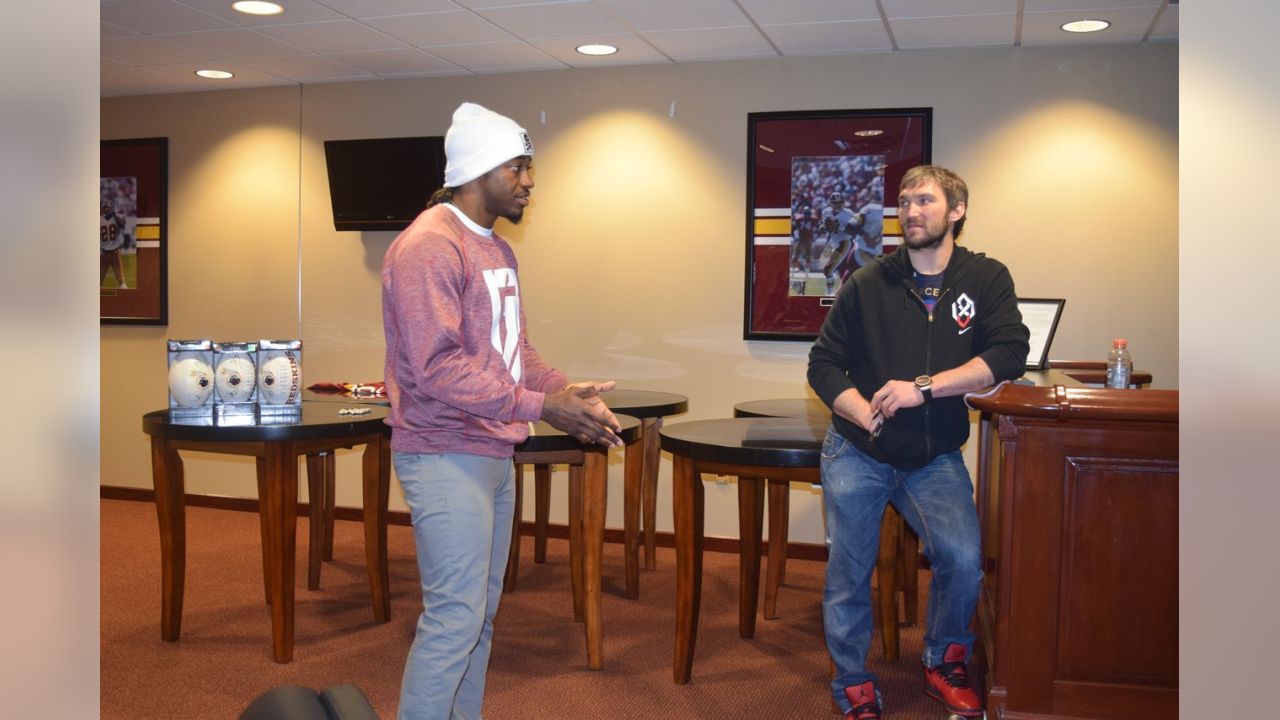 LOOK: Robert Griffin III presents Lionel Messi with Redskins