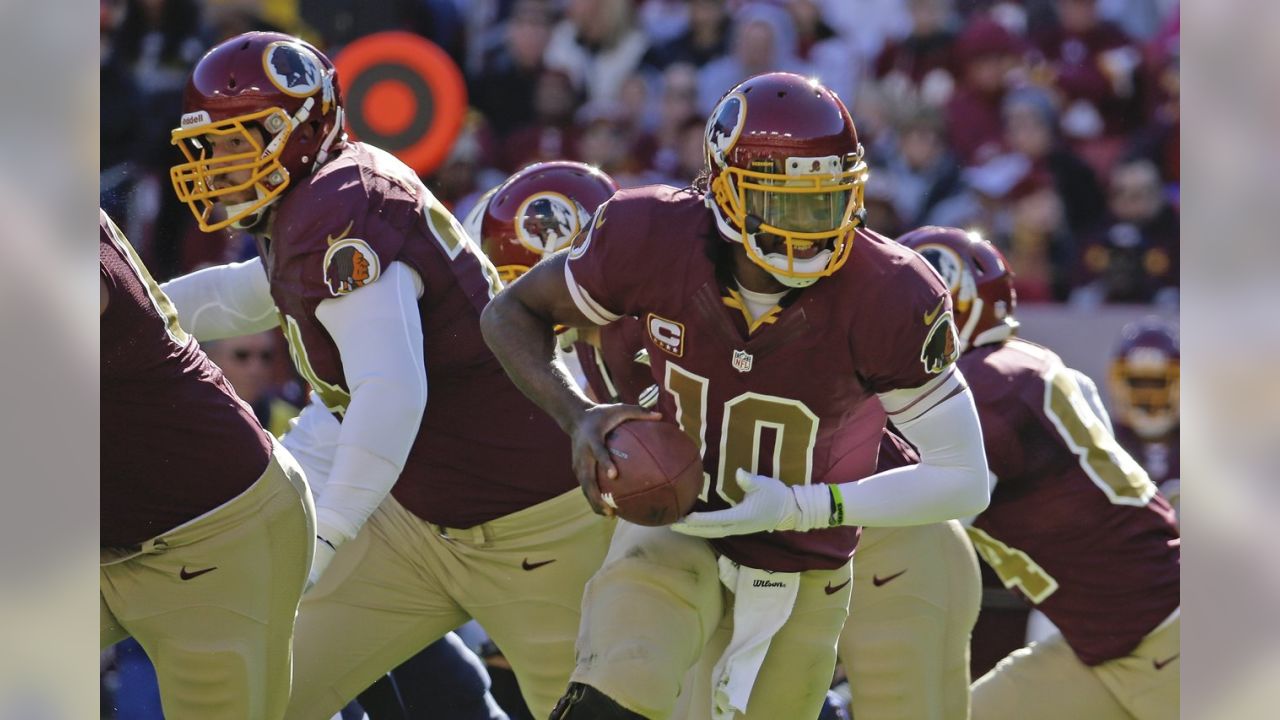 Washington Redskins quarterback Robert Griffin III celebrates a touchdown  by fullback Darrel Young during the second half of a NFL football game  against San Diego Chargers in Landover, Md., Sunday …