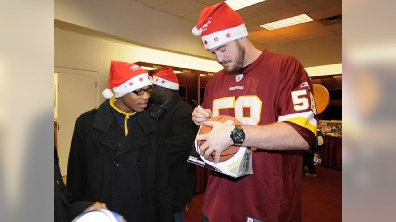 A Washington Redskins cheerleader performs in a Santa Claus costume,  holding a gift during a break in the NFL action between the Redskins and  the Dallas Cowboys, at FedEx Field, Landover Maryland