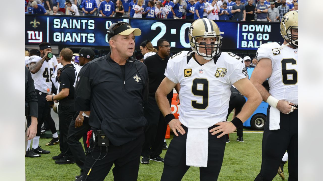 New Orleans Saints and former San Diego quarterback Drew Brees and General  Manager Mickey Loomis, right, hold a Saints jersey presented to Brees  during a news conference at the New Orleans Saints