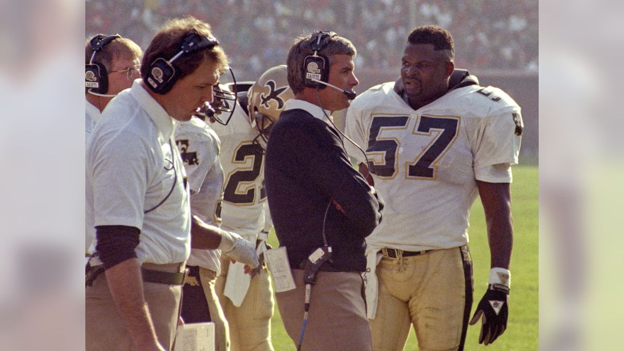 New Orleans Saints linebacker- Pat Swilling arounds around C. Miller-Press  Photo