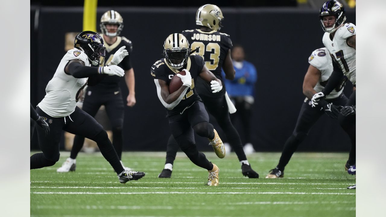 The reflection of New Orleans Saints running back Alvin Kamara (41) is seen  in his visor as he runs through drills at the team's NFL football minicamp  in Metairie, La., Thursday, June