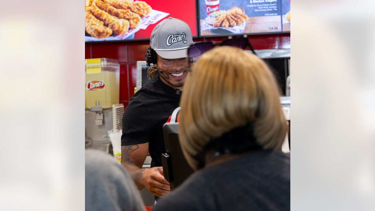 Saints safety Tyrann Mathieu works at Raising Cane's to raise