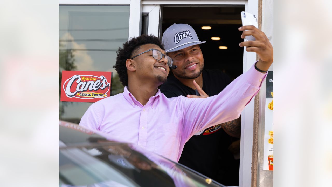 Saints safety Tyrann Mathieu works at Raising Cane's to raise