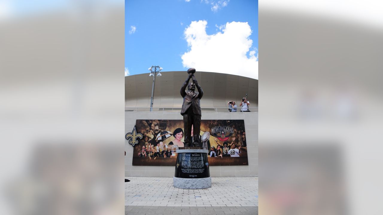 What's the story behind the Tom Benson statue outside the