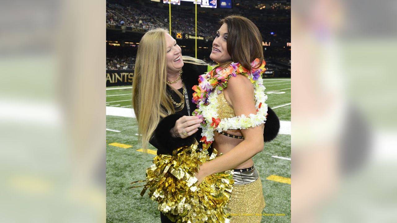 A New Orleans Saints cheerleader appears to be waving flaming pom poms  during the introduction of the team prior to a preseason game between the  Saints and the Baltimore Ravens at the