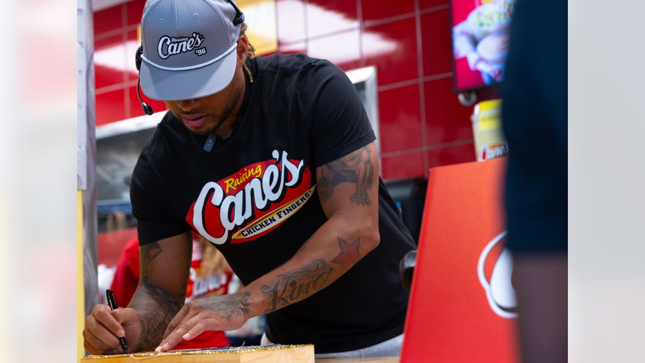 Saints safety Tyrann Mathieu works at Raising Cane's to raise