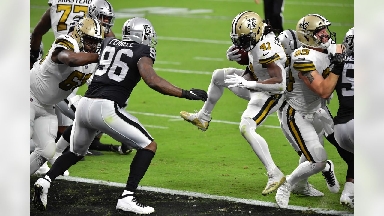 The reflection of New Orleans Saints running back Alvin Kamara (41) is seen  in his visor as he runs through drills at the team's NFL football minicamp  in Metairie, La., Thursday, June