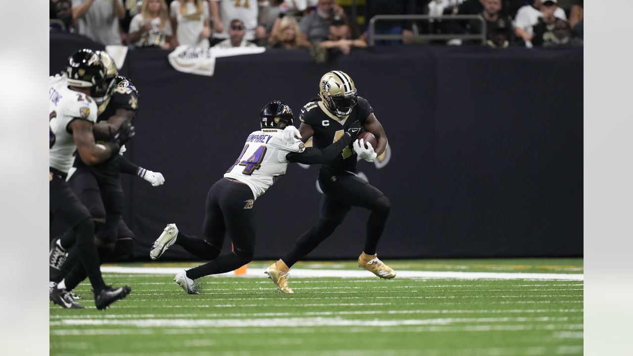 The reflection of New Orleans Saints running back Alvin Kamara (41) is seen  in his visor as he runs through drills at the team's NFL football minicamp  in Metairie, La., Thursday, June