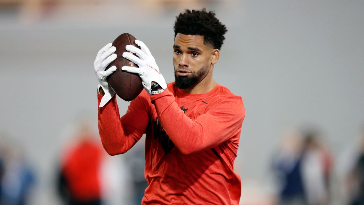 New Orleans Saints wide receiver Chris Olave wears his helmet showing an  American flag, Cuban flag and the Crucial Catch logo before an NFL football  game between the Saints and the Seattle