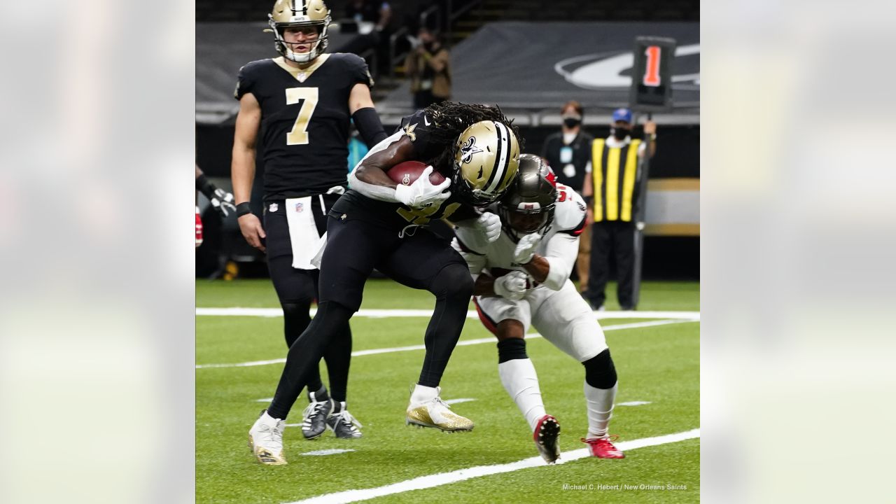 The reflection of New Orleans Saints running back Alvin Kamara (41) is seen  in his visor as he runs through drills at the team's NFL football minicamp  in Metairie, La., Thursday, June