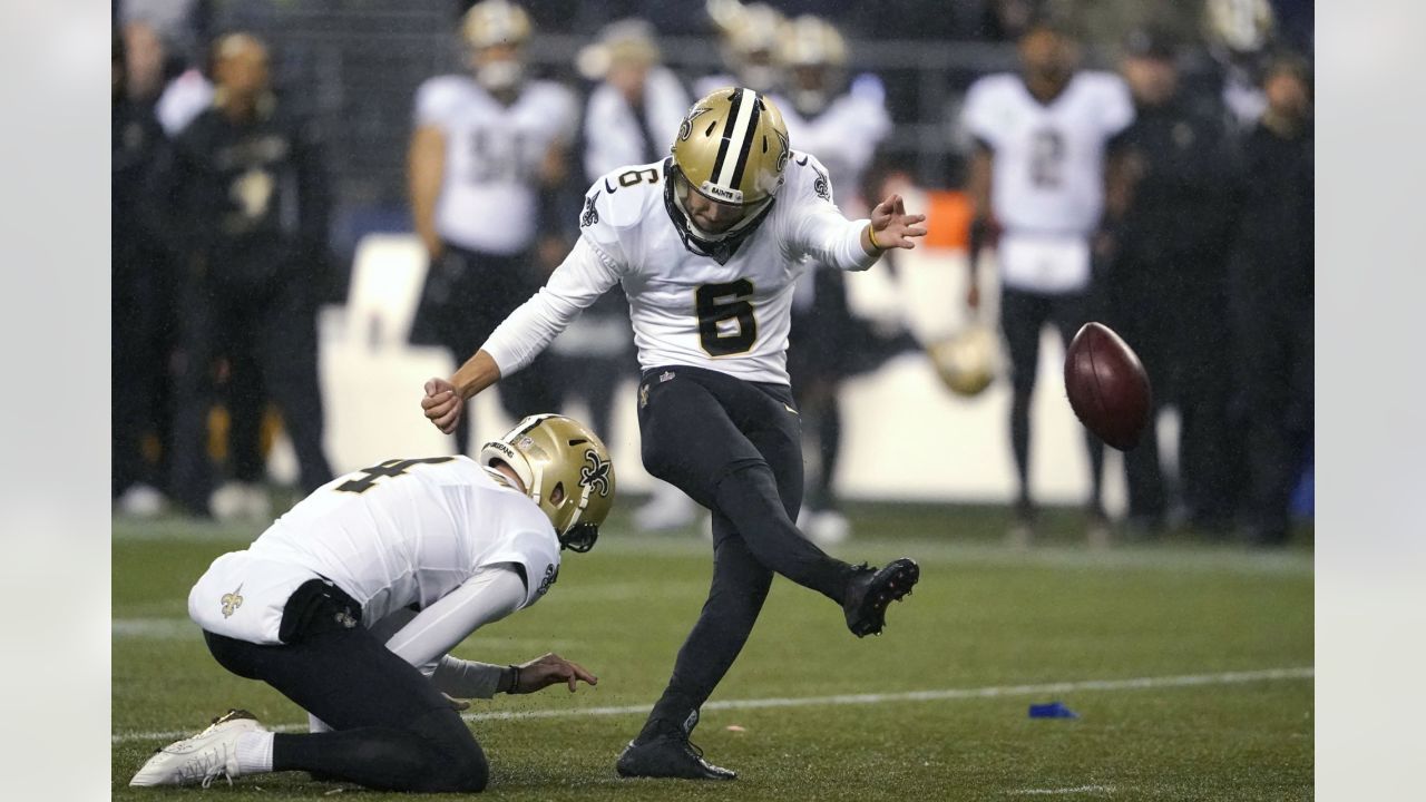 The referee performs the coin toss before an NFL football game between the  New Orleans Saints and the Seattle Seahawks in New Orleans, Sunday, Oct. 9,  2022. The Saints won 39-32. (AP