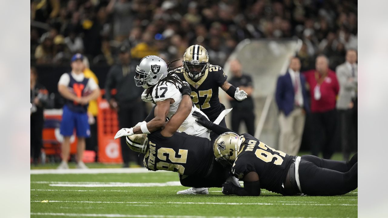 New Orleans Saints cornerback Alontae Taylor, left, tackles