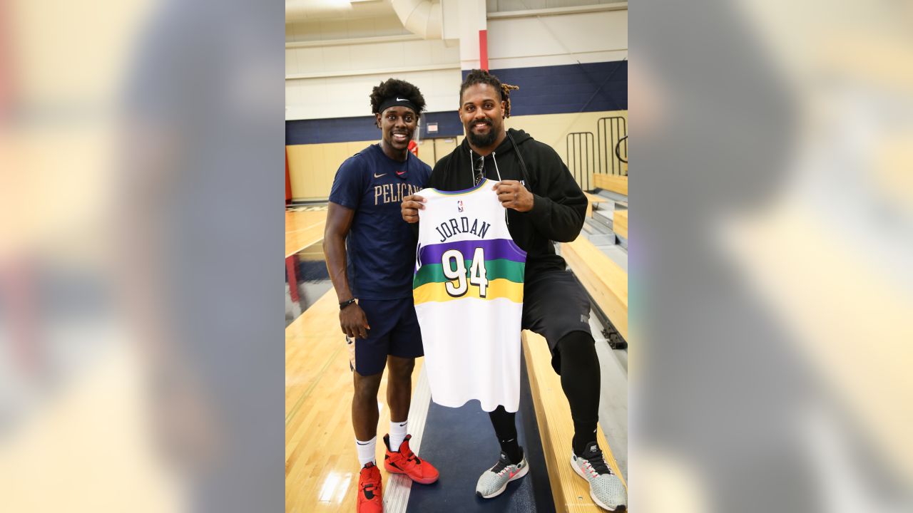 Cam Jordan Receives Custom Pelicans Jersey from Jrue Holiday Photo