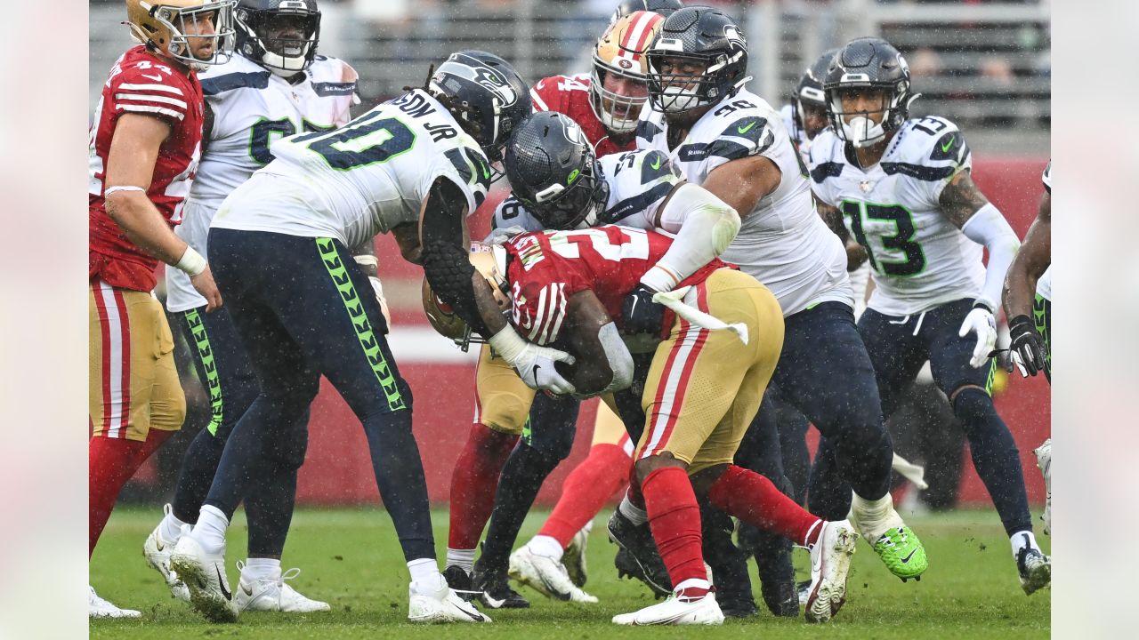 SEATTLE, WA - NOVEMBER 27: Seattle Seahawks defensive tackle Al Woods (99)  brings down Las Vegas Rai