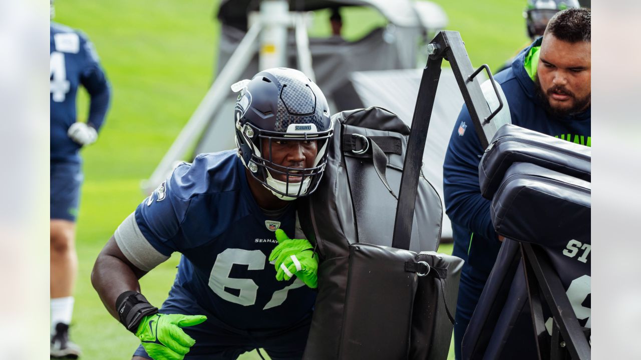 Seattle Seahawks tackle Charles Cross (67) warms up before playing against  the Los Angeles Rams in