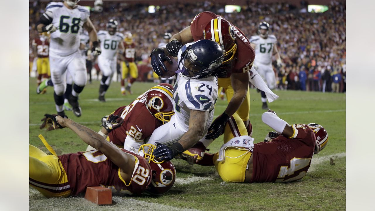 Washington Redskins halfback Chris Cooley is tackled by Seattle Seahawks  strong safety Michael Boulware in the second quarter during their NFC  divisional playoff football game in Seattle, Saturday, Jan. 14, 2006. (AP