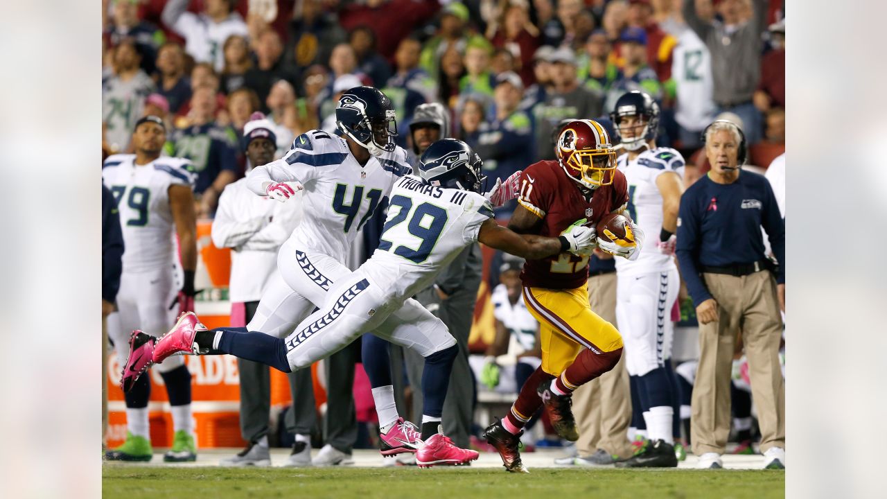 Washington Redskins halfback Chris Cooley is tackled by Seattle Seahawks  strong safety Michael Boulware in the second quarter during their NFC  divisional playoff football game in Seattle, Saturday, Jan. 14, 2006. (AP