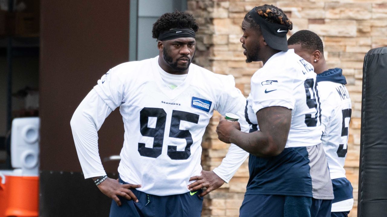 Seattle Seahawks wide receivers John Ursua (15) and Gary Jennings (11)  watch drills on the first