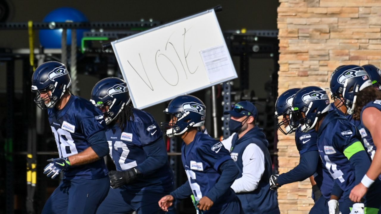 Seattle Seahawks linebacker Jordyn Brooks (56) tosses a signed ball back to  a fan during the NFL football team's training camp, Thursday, Aug. 3, 2023,  in Renton, Wash. (AP Photo/Lindsey Wasson Stock