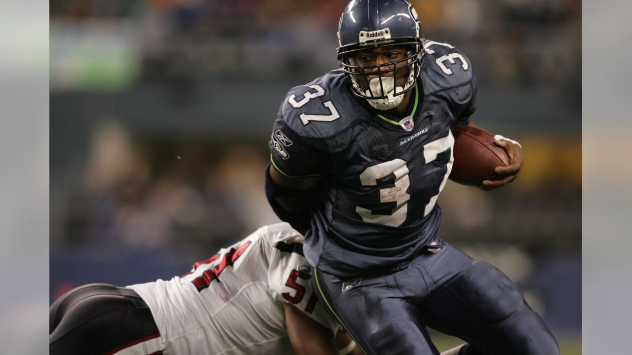 Seahawks Shaun Alexander, right, runs the ball behind a block by News  Photo - Getty Images