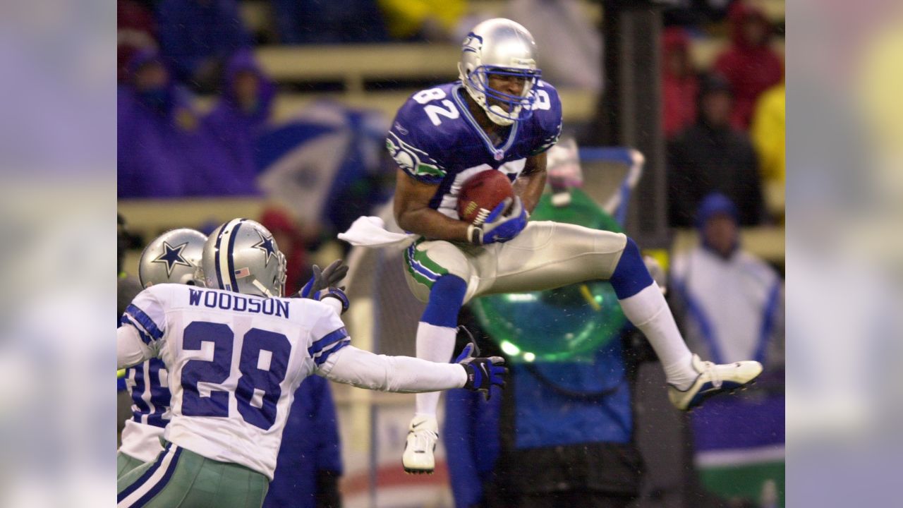 Darren Woodson of the Dallas Cowboys walking on the field during a