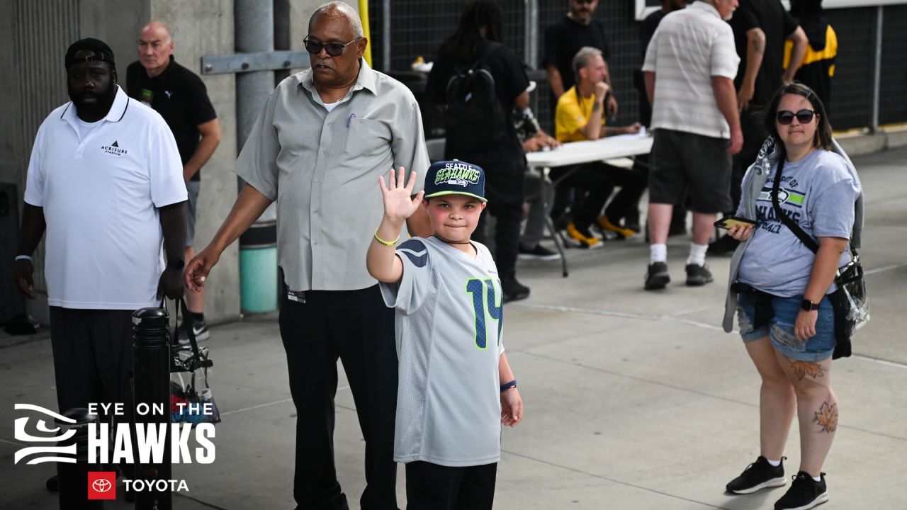 A Seattle Seahawks fan wearing a Russell Wilson jersey waves a