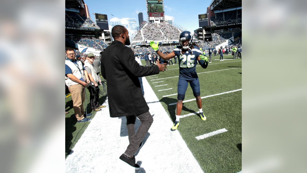 Seattle Seahawks Kam Chancellor, left and Russell Wilson, right, hold a 12th  Man flag after beating the Green Bay Packers 28-22 for the NFC Championship  at CenturyLink Field in Seattle, Washington on