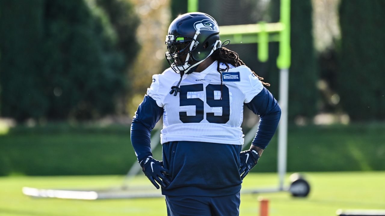 Seattle Seahawks linebacker Jordyn Brooks (56) tosses a signed ball back to  a fan during the NFL football team's training camp, Thursday, Aug. 3, 2023,  in Renton, Wash. (AP Photo/Lindsey Wasson Stock