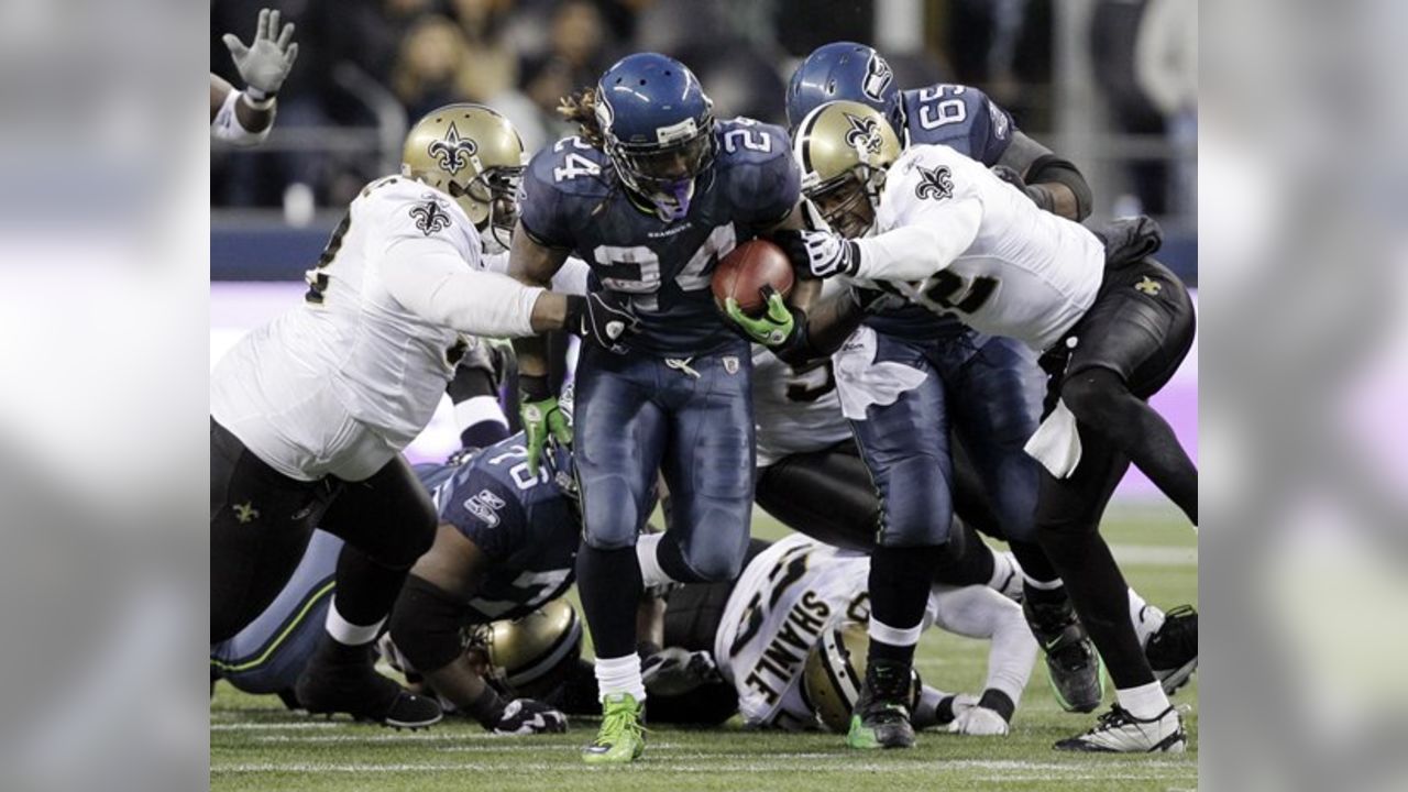 A stunned New Orleans Saints' Roman Harper walks off the field as the  Seattle Seahawks' celebrate their 41-36 win over the Super Bowl Defending  Champions in the NFC's wild-card playoff game on