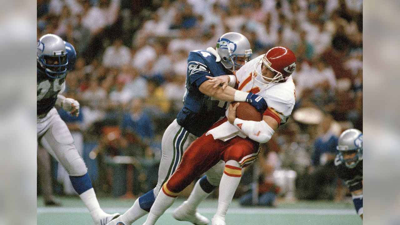 Seattle Seahawks - Seahawks quarterback Rick Mirer attempts to elude  Derrick Thomas during an NFL Football game against the Kansas City Chiefs  on January 2, 1994 in Kansas City, Missouri.