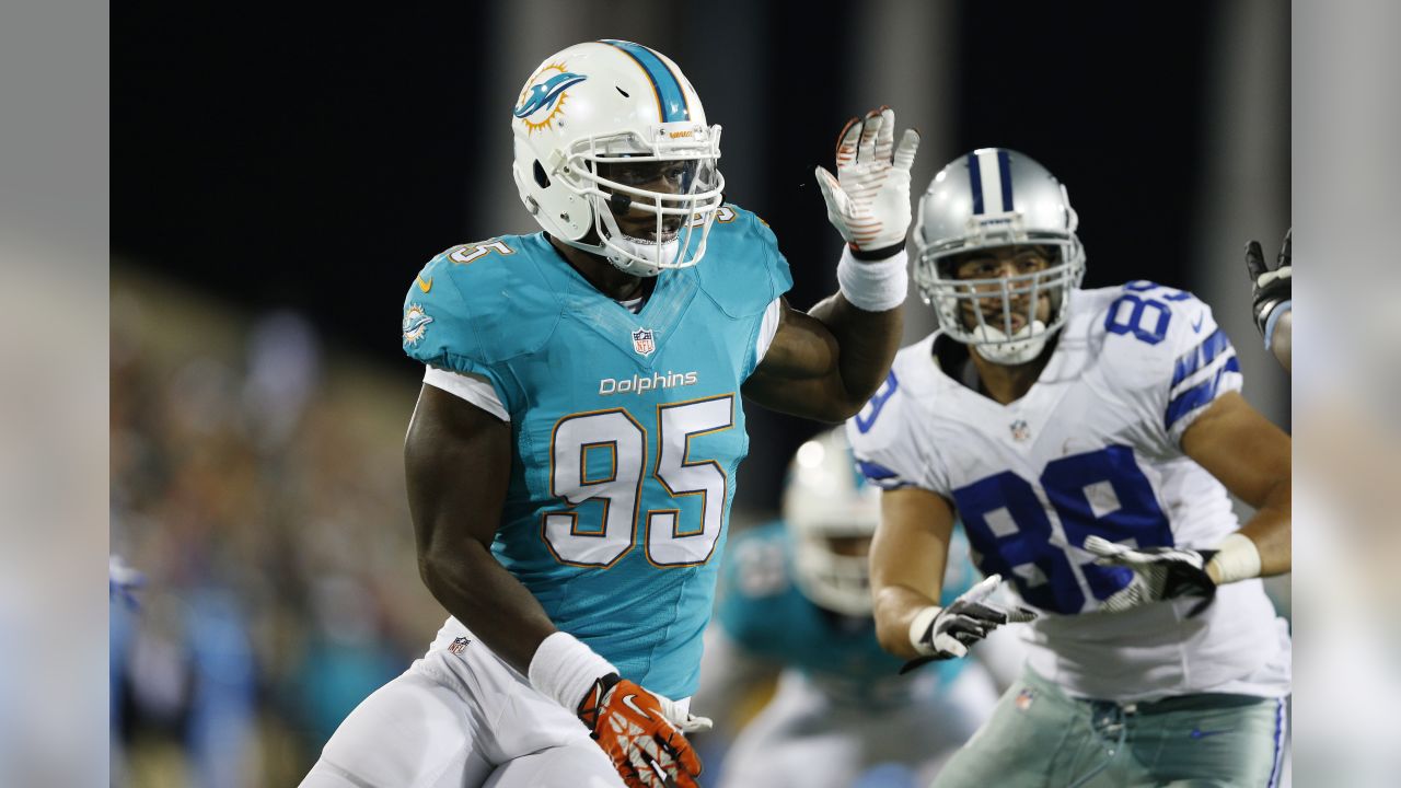 Dion Jordan, defensive end from Oregon, holds up a Dolphins Jersey