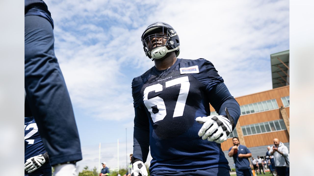 Seattle Seahawks tackle Charles Cross (67) warms up before playing against  the Los Angeles Rams in