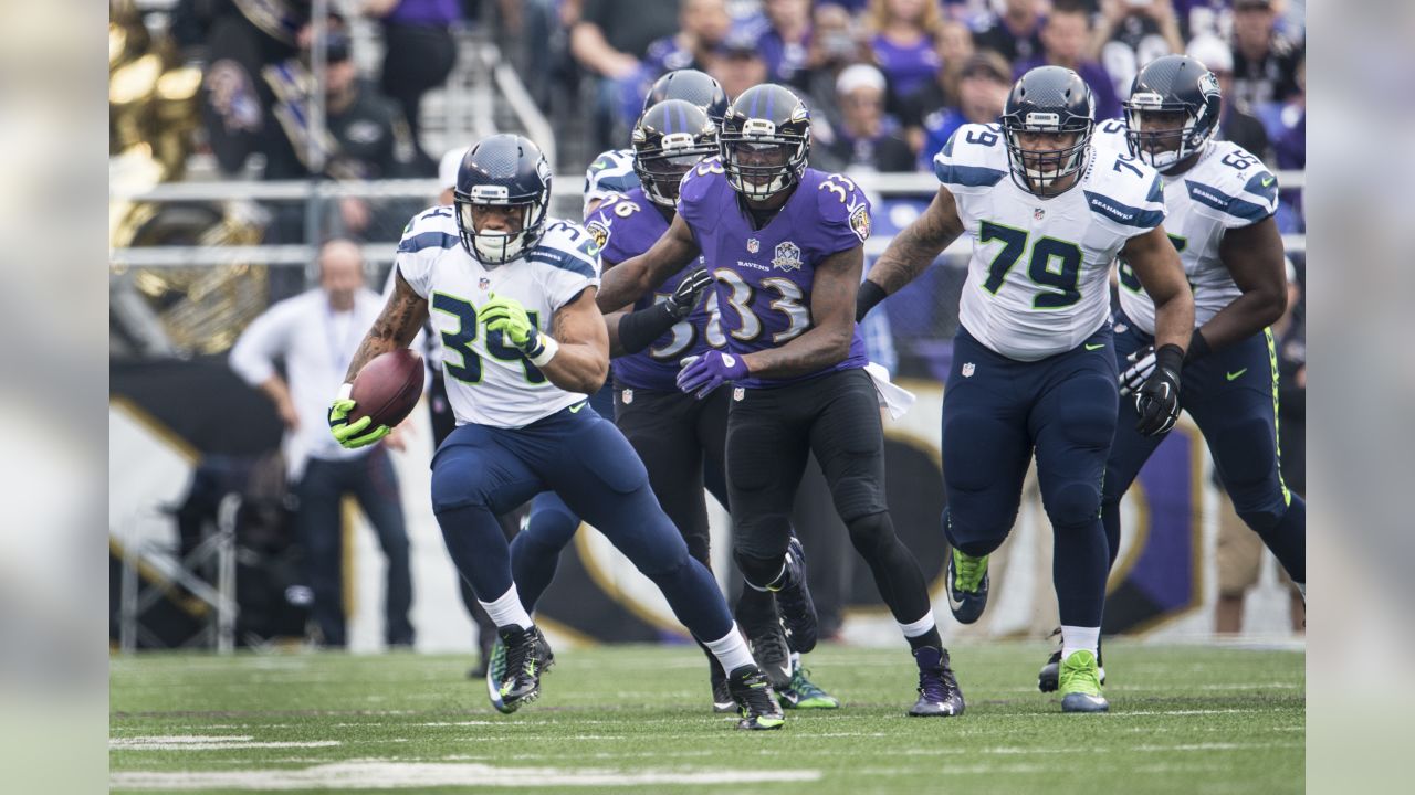 Seattle Seahawks cornerback Richard Sherman (25) and outside linebacker  K.J. Wright (50) team up to tackle Arizona Cardinals running back David  Johnson (31) at CenturyLink Field in Seattle, Washington on December 24