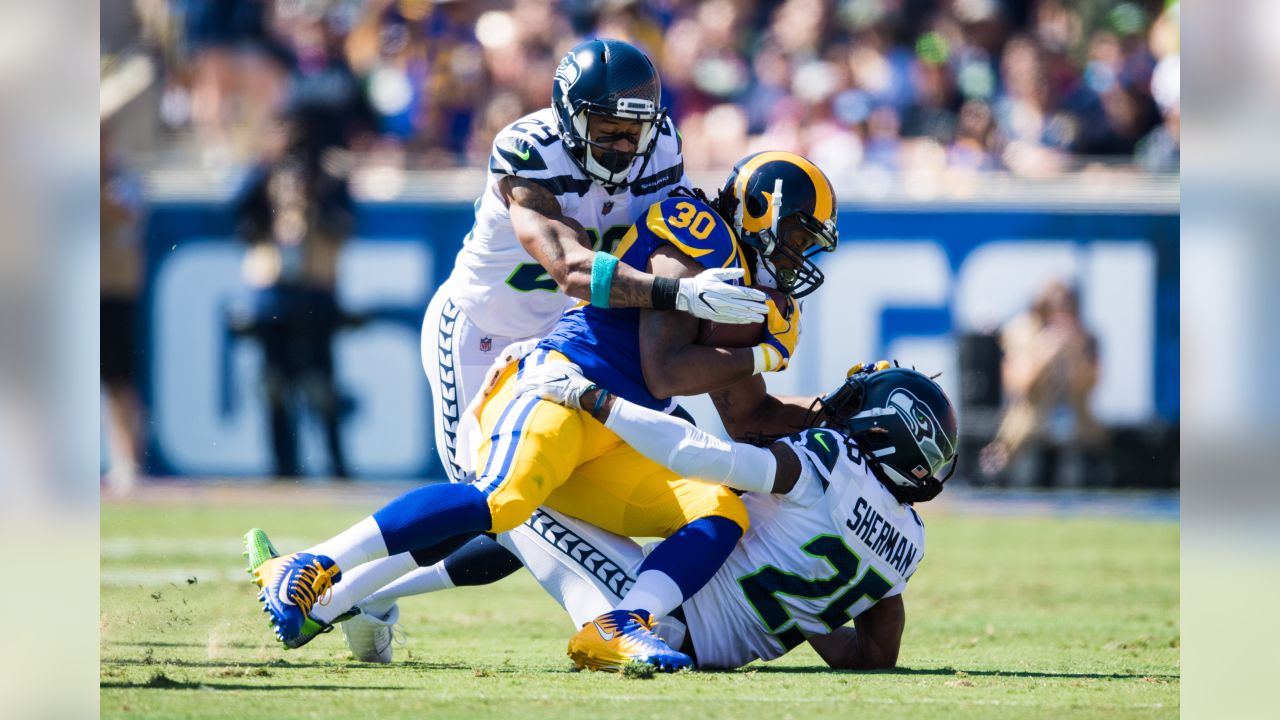 Seattle Seahawks defensive end Frank Clark (55) intercepts a pass intended  for Los Angeles Rams running back Todd Gurley (30) to stop a drive during  the first quarter at CenturyLink Field on