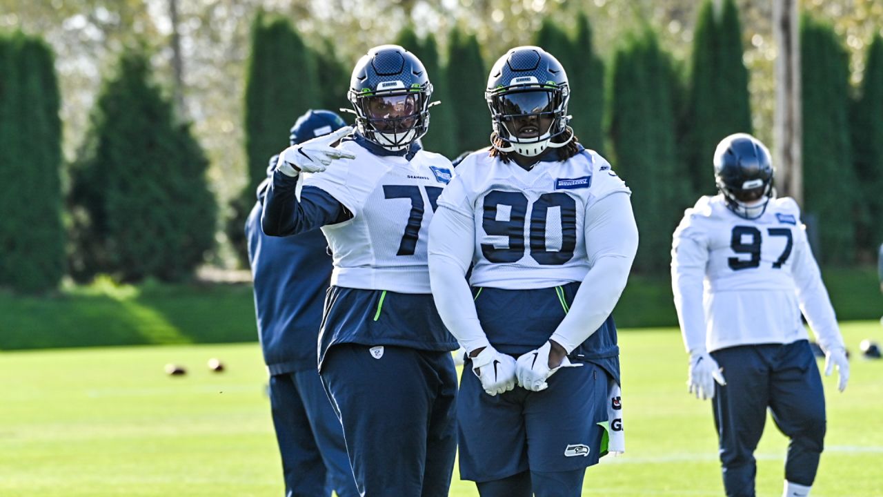 Seattle Seahawks linebacker Jordyn Brooks (56) tosses a signed ball back to  a fan during the NFL football team's training camp, Thursday, Aug. 3, 2023,  in Renton, Wash. (AP Photo/Lindsey Wasson Stock