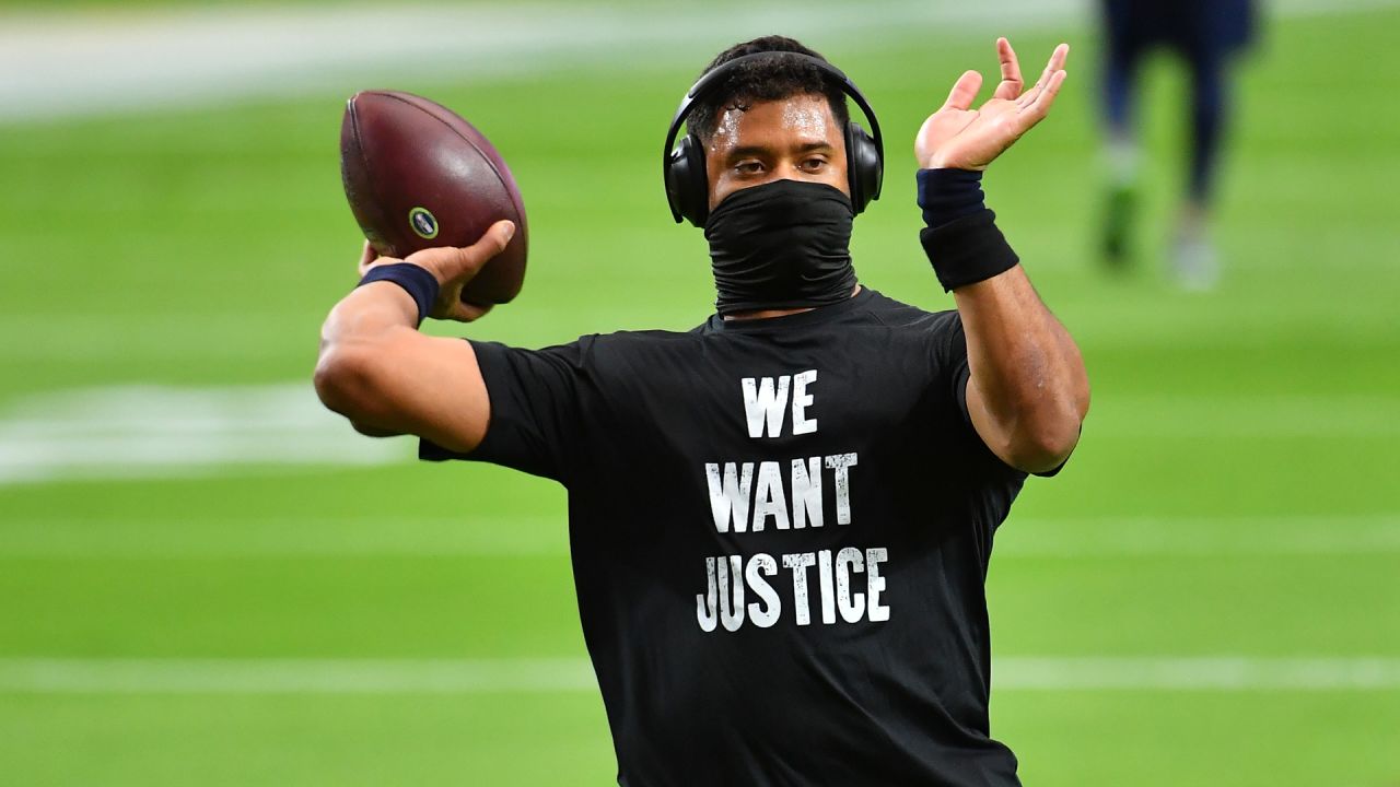 Seattle Seahawks mascot, Blitz, console Seattle Seahawks quarterback  Russell Wilson (3) as he departs the field after their 31-34 loss to the  Arizona Cardinals at CenturyLink Field in Seattle, Washington on December