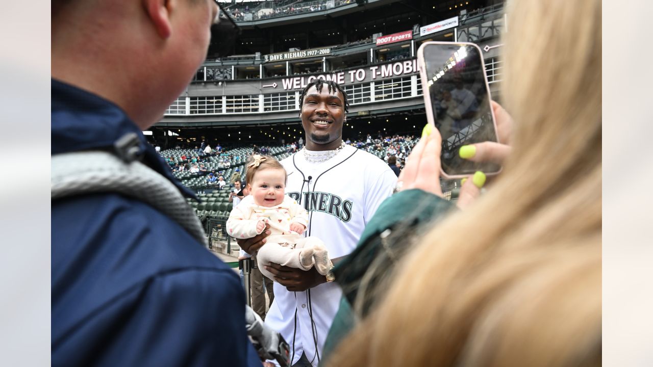 NFL football tackle Charles Cross, the Seattle Seahawks' first-round draft  pick, throws out the first pitch of a baseball game between the Seattle  Mariners and the Houston Astros, Sunday, May 29, 2022