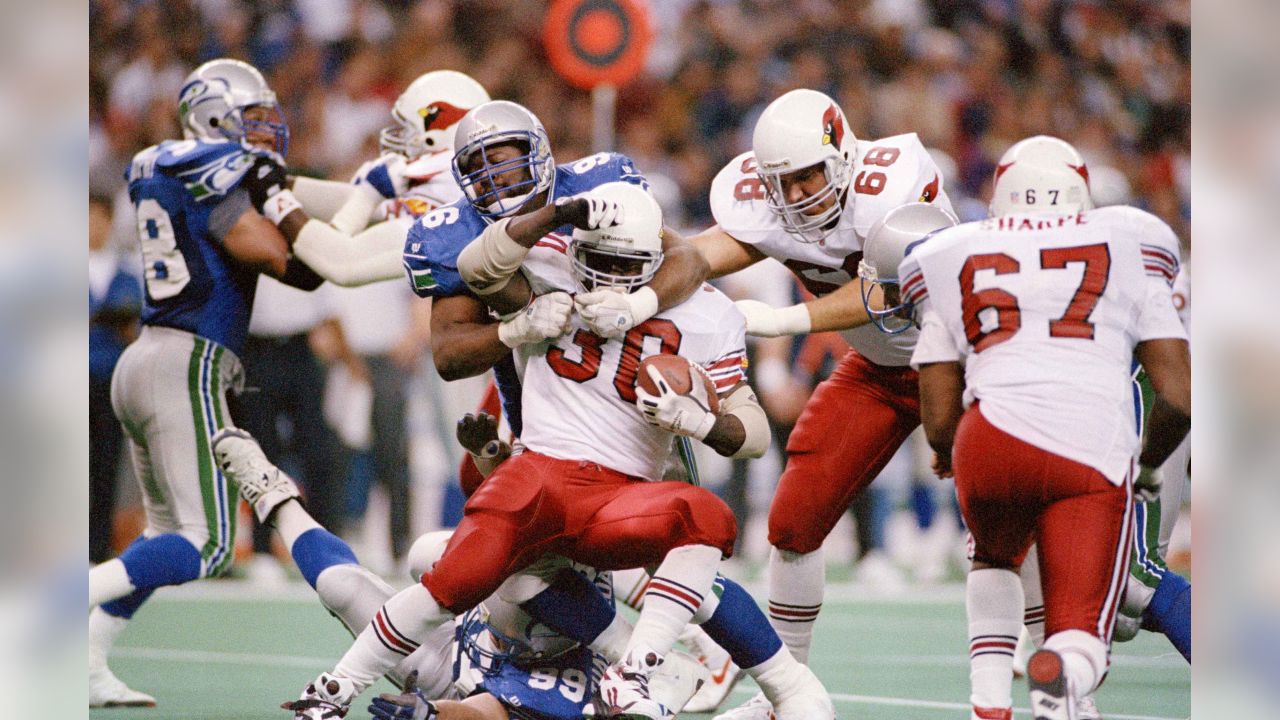 Seattle Seahawks cornerback Richard Sherman (25) and outside linebacker  K.J. Wright (50) team up to tackle Arizona Cardinals running back David  Johnson (31) at CenturyLink Field in Seattle, Washington on December 24