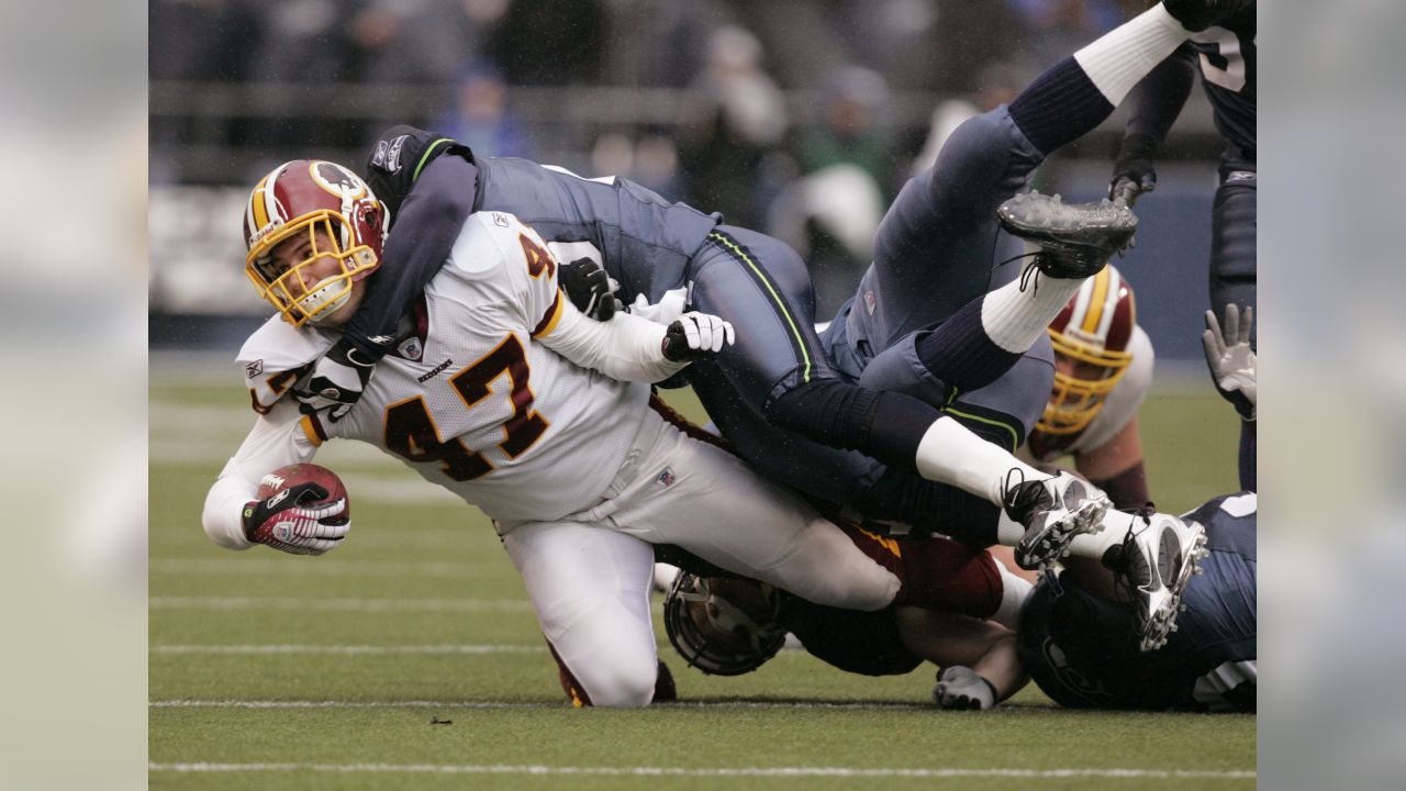 Washington Redskins halfback Chris Cooley is tackled by Seattle Seahawks  strong safety Michael Boulware in the second quarter during their NFC  divisional playoff football game in Seattle, Saturday, Jan. 14, 2006. (AP