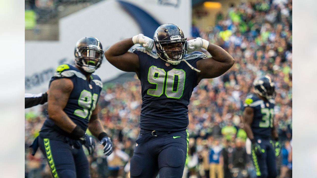 Seahawks LB Darrell Taylor runs onto the field after an