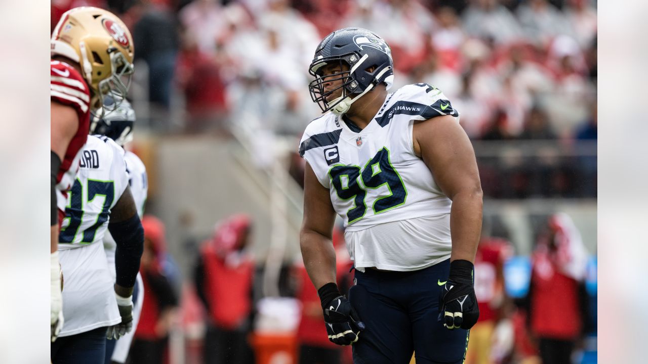 SEATTLE, WA - NOVEMBER 27: Seattle Seahawks defensive tackle Al Woods (99)  brings down Las Vegas Rai