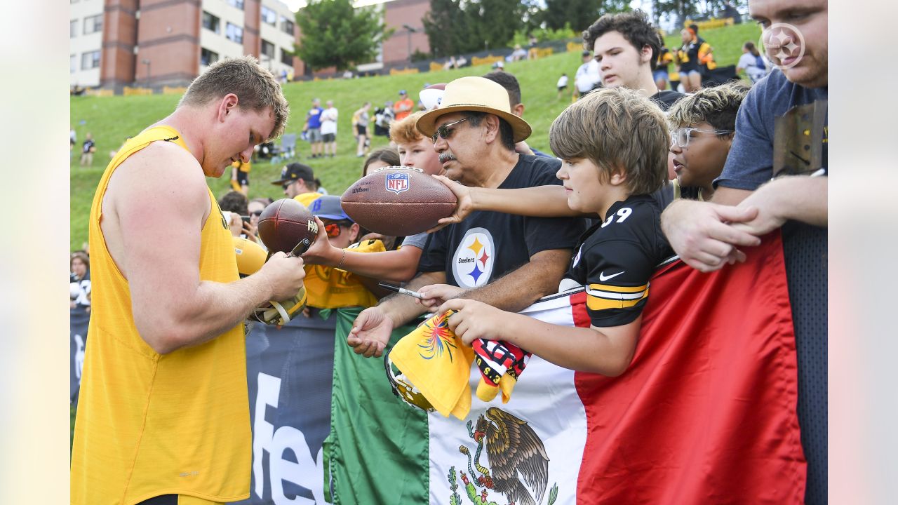 A young Pittsburgh Steelers fan poses for a photo with Pittsburgh Steelers  mascot Steely McBeam during Back Together Weekend at the NFL football  team's training camp at St. Vincent's College in Latrobe