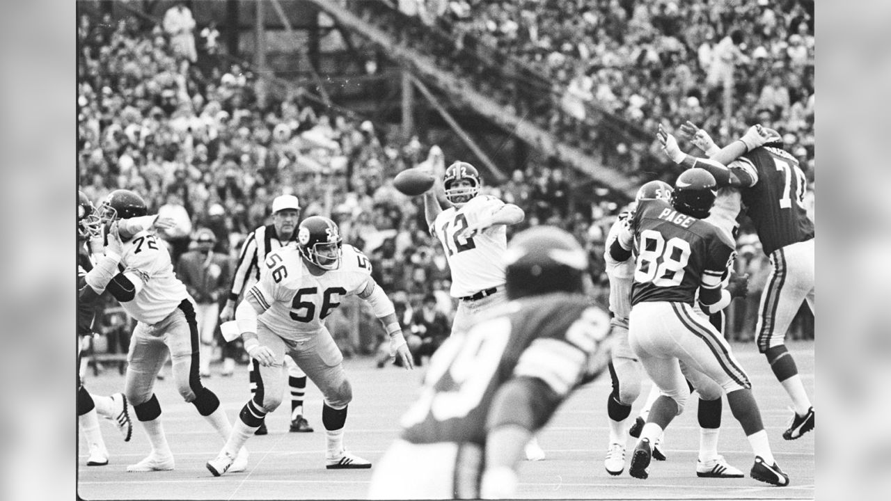 Terry Bradshaw tip-toes over a plank to avoid the flooded field at Tulane  Stadium just two days before their victory over the Vikings in Super Bowl IX  - 1975 : r/steelers