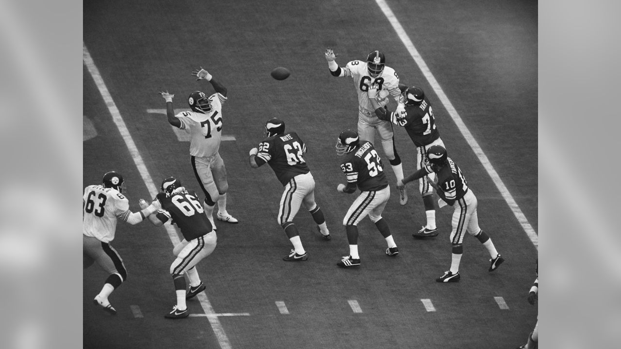 Terry Bradshaw tip-toes over a plank to avoid the flooded field at Tulane  Stadium just two days before their victory over the Vikings in Super Bowl IX  - 1975 : r/steelers