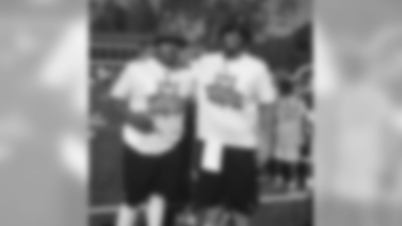 Joshua Garnett with Andrus Peat at a football camp