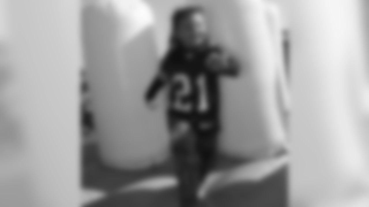 A young fan enjoys one of the interactive games at Faithful City