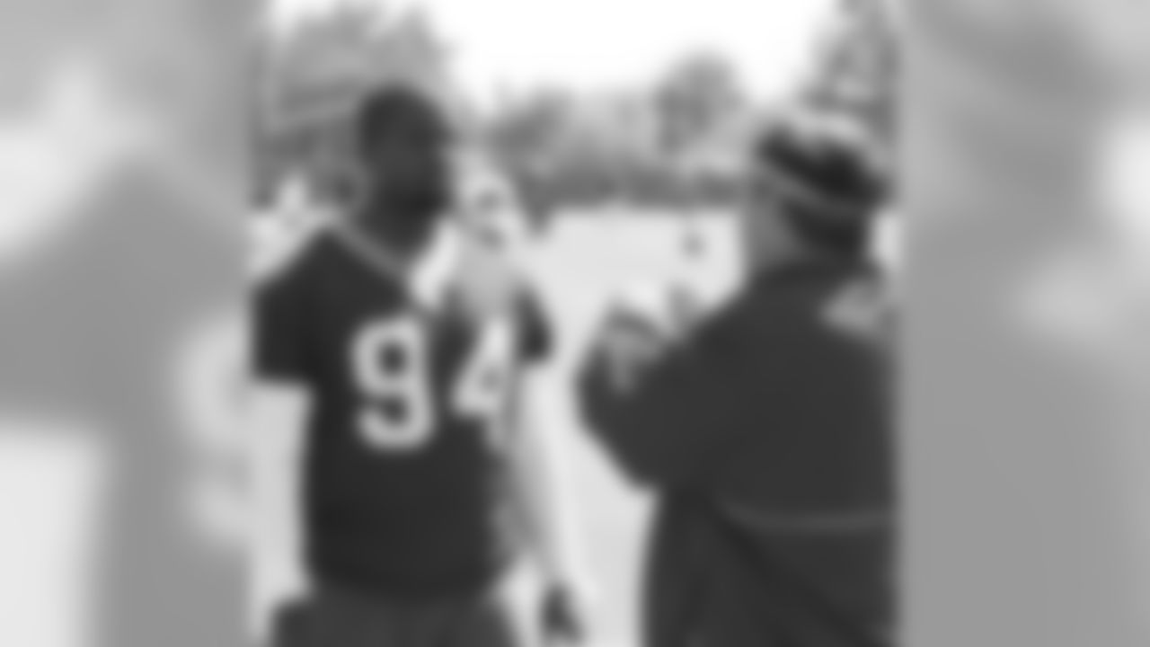 DE Marques Douglas gets some tips from his coach Jim Tomsula